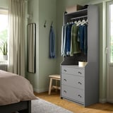 Modern gray bedroom with HAUGA wardrobe, mirror, and wooden bench, light green walls.
