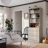 Modern bedroom with HAVSTA grey chest & bookshelf, aligned shelves.