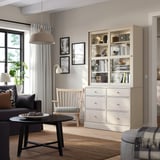 HAVSTA beige storage: glass doors, 6 drawers, near window and sofa.