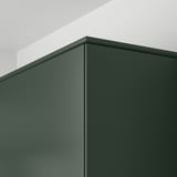 Dark green kitchen cabinet panels with straight lines and smooth surfaces, mounted on a white wall, demonstrating integrated cabinet design.