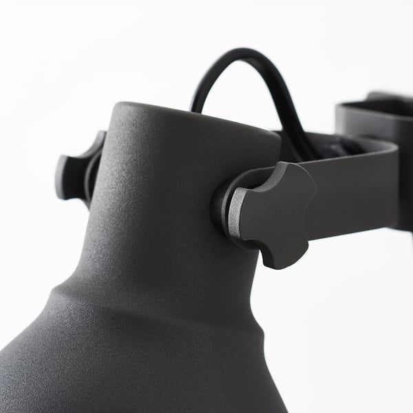 Black adjustable metal lamp close-up, showing robust design and stainless-steel handle.