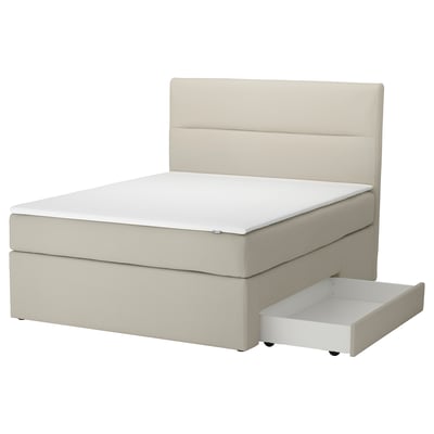 A beige HEMFJÄLLET divan bed with storage drawers. The bed frame has a simple, modern design with a soft headboard and is upholstered in fabric.