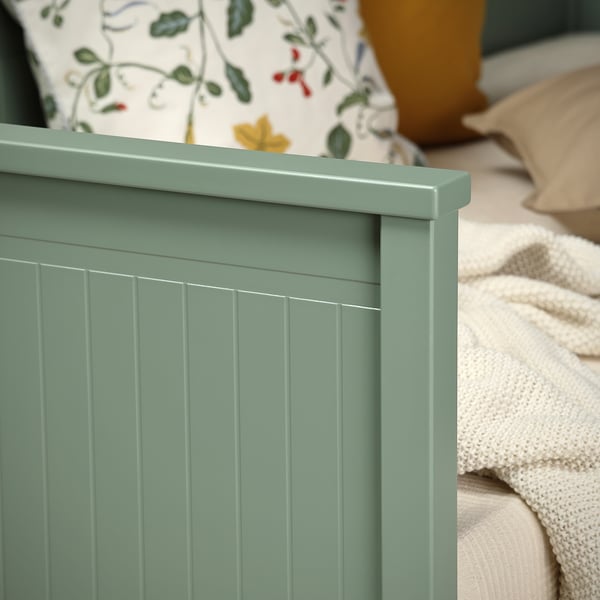 Modern light green day-bed with vertical panel design, providing comfort and style for small spaces.