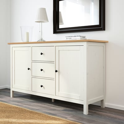 White HEMNES sideboard with 3 drawers & 3 doors. Made of solid pine, fits well against wall. Mirror & lamp on top; rug below.