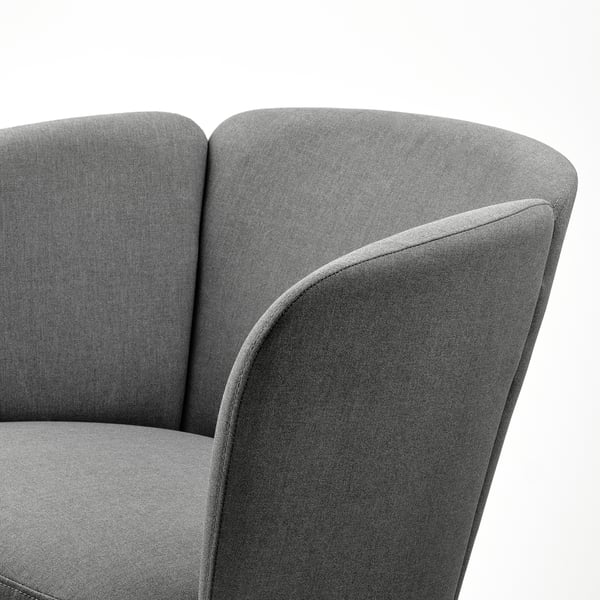 Modern upholstered armchair with smooth, rounded shapes. High-quality fabric, supportive design, elegant finish.