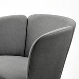 Modern upholstered armchair with smooth, rounded shapes. High-quality fabric, supportive design, elegant finish.