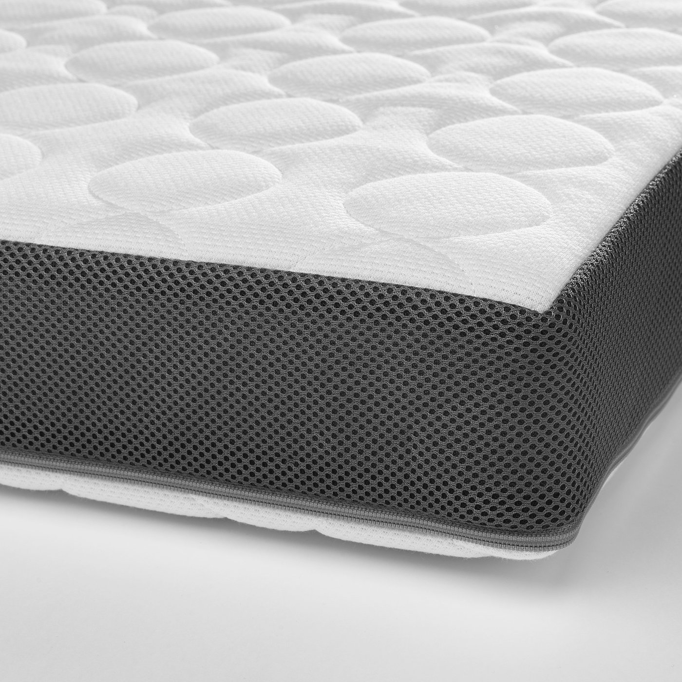Close-up of a high-quality, textured mattress with a reusable, washable cover.