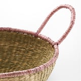 Handcrafted woven basket with sturdy handles, made from natural sedge material. Displaying intricate texture and craftsmanship.