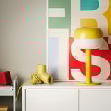 Colorful HORNFELS extension on desk, sized similar to small lamp, with playful design.