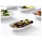 Small white bowl filled with mixed olives. Part of IKEA 365+ stackable dinnerware series, known for durability and timeless design.