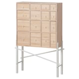 Light-colored wooden cabinet with 12 drawers and metallic legs; minimalist design.