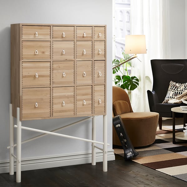 IKEA PS SINKA: 12-drawer dresser with white handles, natural wood, black frame, modern room.
