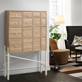 IKEA PS SINKA: 12-drawer dresser with white handles, natural wood, black frame, modern room.