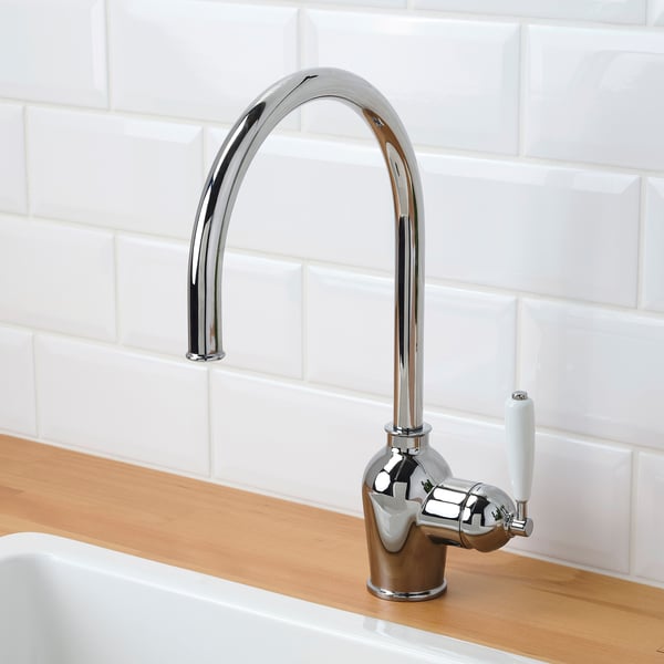 Modern kitchen faucet with chrome finish and white lever. Automatic water flow via sensor technology.