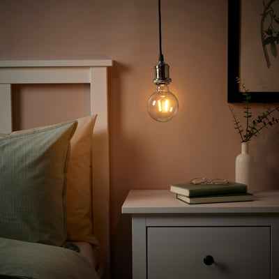 Cozy bedroom with JÄLLBY lamp, bed, and nightstand decor.