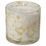JÄMLIK candle in glass with yellow-white speckles, cylindrical shape, sweet vanilla scent.