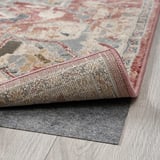 Soft, pastel oriental-style rug with durable, stain-resistant material and non-slip backing.