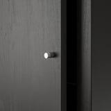 A dark gray KALLAX shelf unit, sleek and modern. Stylish knobs for drawers, set against a smooth, finished surface.