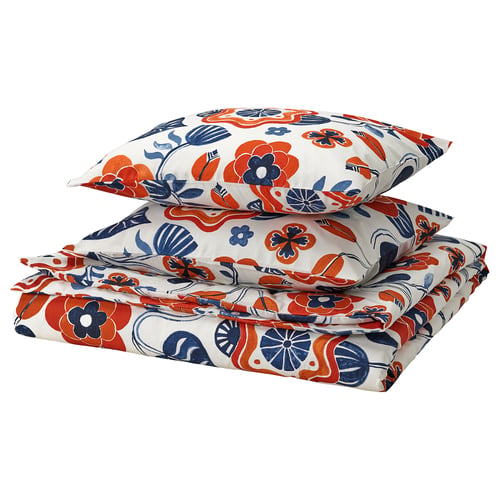A folded KANONVISKA bedding set. It bright floral designs in red and blue on a white background. The material is a soft blend of cotton and viscose.