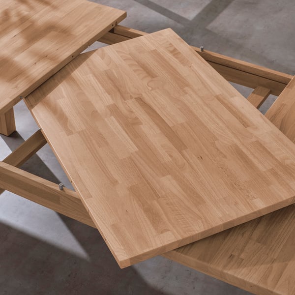 Wooden extendable table with leaf stored underneath, seating 6-8 people, made from solid rubberwood.