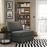 Grey KIVIK sofa-bed in cozy room, perfect for small spaces with modern design.