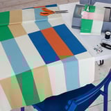 Colorful pre-cut fabric on sewing table, vibrant grid pattern by hannah wilcox.