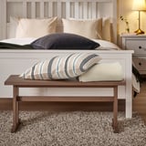 KLIMPFJÄLL wooden bench in bedroom with pillows, under bed, next to nightstand.