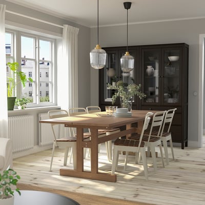 Cozy dining area with KLIMPFJÄLL table & chairs, glass cabinet, natural light.