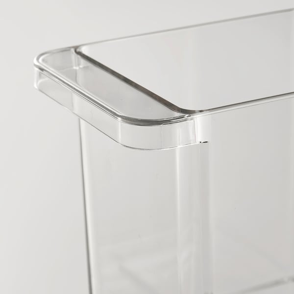 Clear plastic storage box with rounded handle, designed for fridge organization. Transparent, stackable, with a smooth, sturdy build.