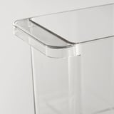 Clear plastic storage box with rounded handle, designed for fridge organization. Transparent, stackable, with a smooth, sturdy build.