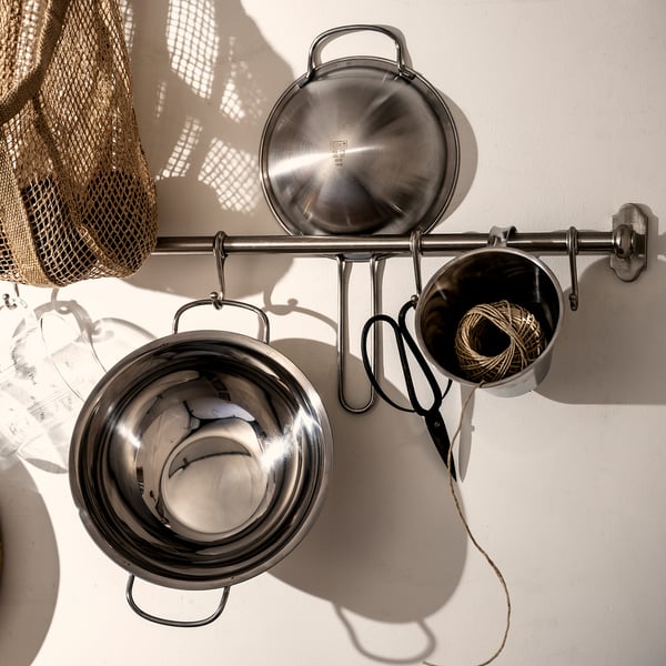 KLOCKREN: shiny silver double boiler insert hangs on metallic rack with scissors, twine, and bag.