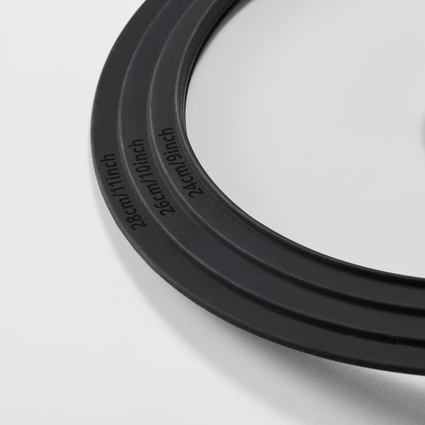 Black silicone rings stacked, labelled 24cm/9inch, 25cm/10inch, 26cm/10inch. Shows quality through clear, precise markings.
