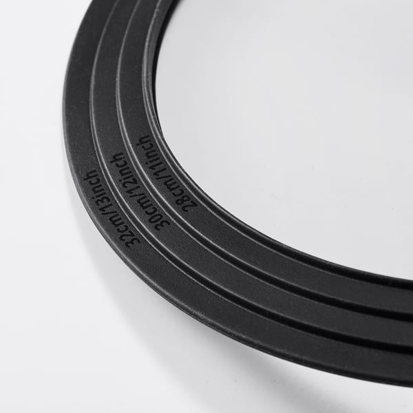 Black rubber band with embossed text, laid on white surface. High quality, durable material.