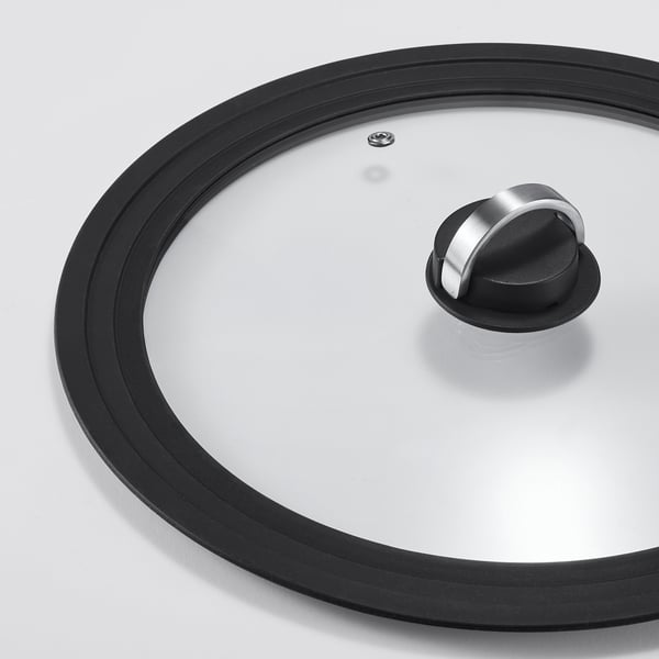 Round glass pot lid with black silicone rim, stainless steel handle, and ventilation hole.