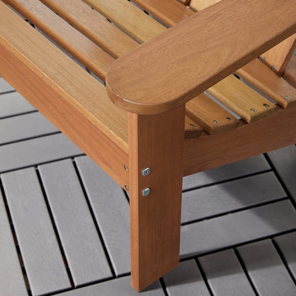 Close-up of wooden furniture leg, showcasing smooth finish and sturdy construction with metal screws for stability.