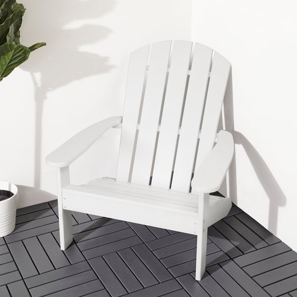 White KLÖVEN adirondack chair on gray deck, large and relaxing with high back and wide armrests.