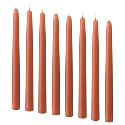 Eight brown KLOKHET candles, straight and cylindrical, made of stearin with cotton wicks, arranged in two rows of four.