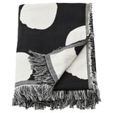 Black and white dotted throw blanket with fringe, made from recycled cotton.