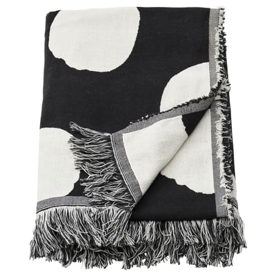 Black and white dotted throw blanket with fringe, made from recycled cotton.