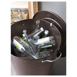 Dark metal bin filled with clear bottles, lid secured on edge. Useful for recycling and easy handling.