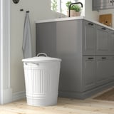Large white KNODD bin in kitchen, steel, tall with handles and lid hook.