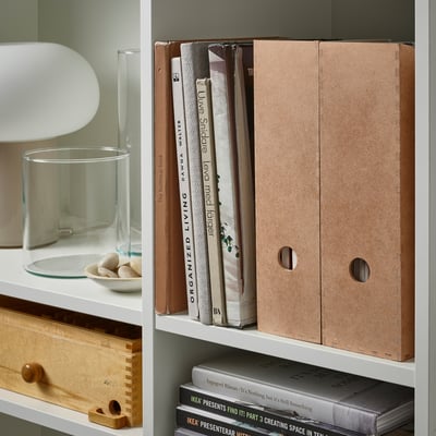 Bookshelf with KNUFF magazine files organizing papers and books.