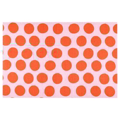 KÖRFÄLTSPIL mat: bright pink with large orange dots, rubber back, rectangular shape.
