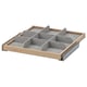 A wooden pull-out drawer organizer with gray fabric compartments for storage.