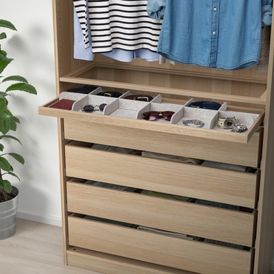 Organized wooden closet with pull-out tray storing accessories.