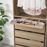 Wooden drawer unit organized with felt dividers for accessories and small items. Easy pull-out tray with compartments for belts, ties, and jewelry.