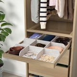 Wooden closet drawer with felt organizers for belts, jewelry, and accessories, pull-out tray with compartments.