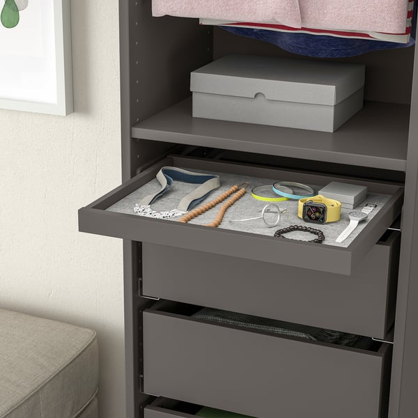 Gray wardrobes pull-out tray displays jewelry, including necklaces, bracelets, and a watch, showcasing effective organization and easy access.