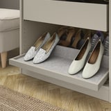 Shoe organizer with pull-out tray, angled for easy view, fitted in wardrobe.