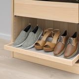 Wooden shoe rack with felt lining holds four pairs of shoes neatly. The grey and tan shoes are shown in a closet drawer, easy to access and organized.